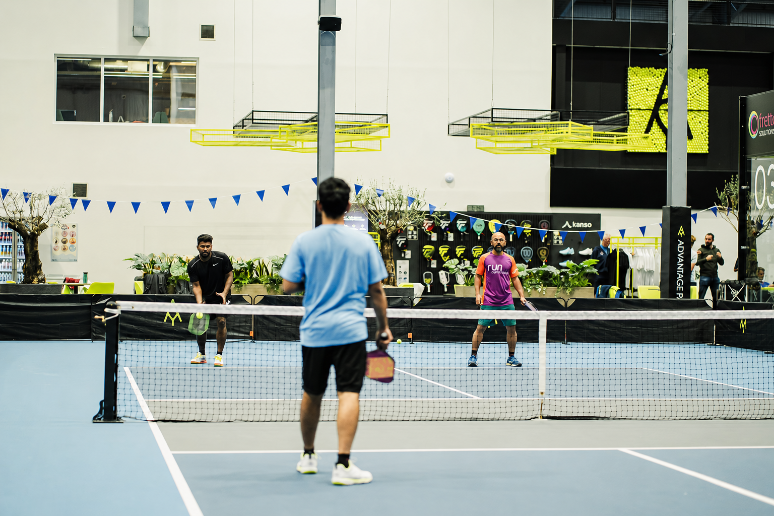 A pickleball match in play on the indoor courts